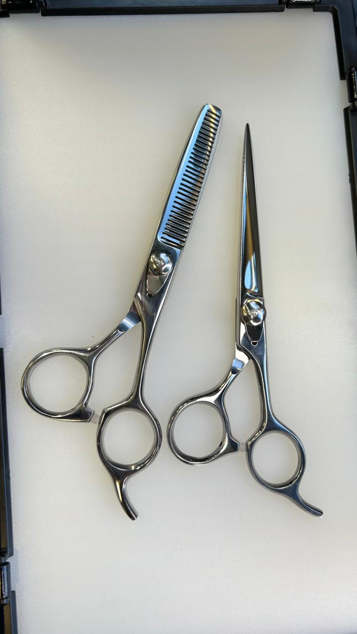 Set of scissors and a comb on a white background